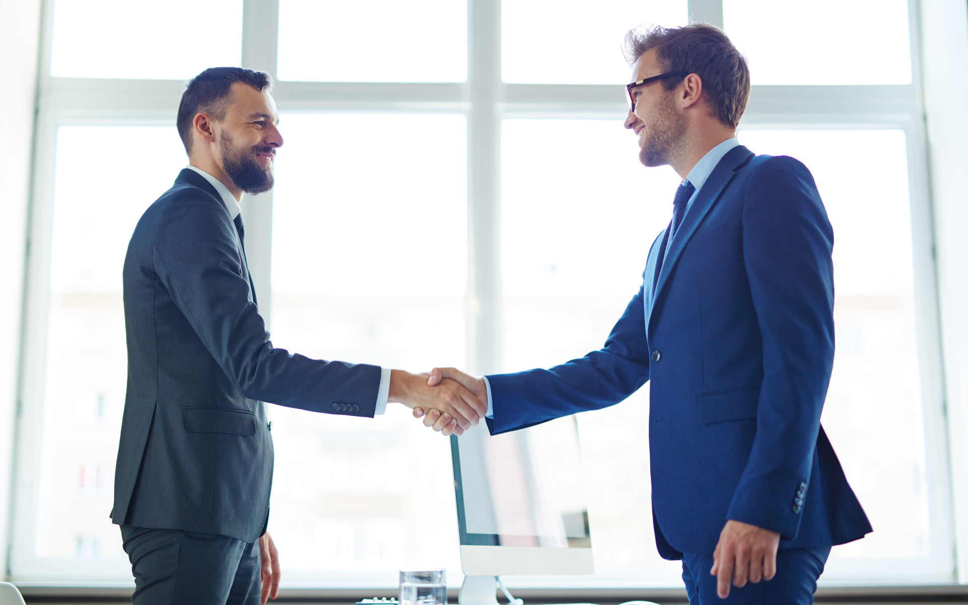 A Satisfied Client Shaking Hands With an AppCorp Expert